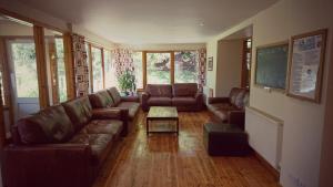 a living room with a couch and a table at Morag's Lodge in Fort Augustus