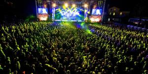 a crowd of people sitting in front of a concert at Apartma M&R in Tolmin