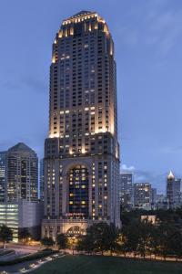 a tall building with lights on it in a city at Four Seasons Hotel Atlanta in Atlanta
