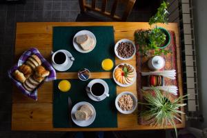 a table with breakfast foods and coffee on it at Hosteria Thiamalu in El Chalten
