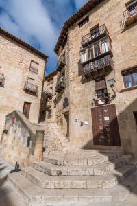 a stone building with stairs leading up to a door at Apartamentos Plaza Mayor in Valderrobres