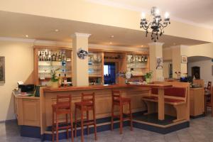 a bar in a restaurant with chairs and a counter at Hatzenporter Paradies in Hatzenport