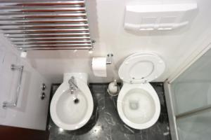 a small bathroom with a toilet and a sink at Happy Rome in Rome