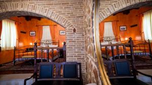 a room with three bunk beds and a brick wall at Acronafplia Pension A in Nafplio