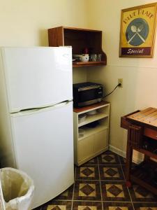 a white refrigerator in a kitchen with a table at Marinette Inn in Marinette
