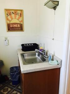 a sink in a kitchen with a counter top at Marinette Inn in Marinette