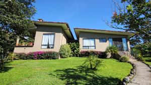 a house with a lawn in front of it at The Guest Suites at Manana Madera in Boquete