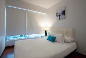 Giường trong phòng chung tại Mariel Hotel Boutique