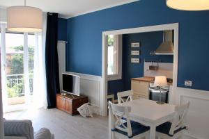 een woonkamer met een tafel en een blauwe muur bij Le Grand Bleu in Bordighera