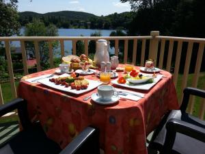 a table with food and drinks on top of a table at Auberge Aux Nuits de Rêve in Sainte-Agathe-des-Monts