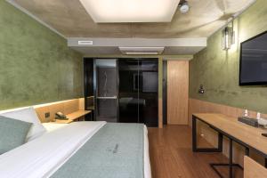 a bedroom with a large bed and a tv at Delight Hotel Jamsil in Seoul