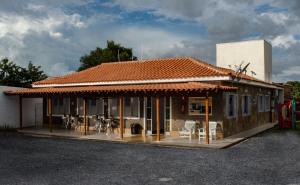 a building with tables and chairs in front of it at Pousada Araxá in Araxá