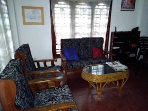 a living room with a couch and a coffee table at Villa O.V.C in Hikkaduwa