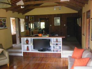 a living room with a television on a white entertainment center at Lejartre's Retreat in Mount James