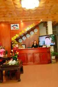a woman standing behind a counter in a salon at Son Ha Hotel SAPA in Sapa