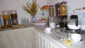 a kitchen counter filled with lots of different types of food at Hotel Riviera in Arenzano