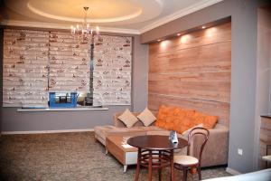 a living room with a couch and a table at Sapar Standart Hotel in Shymkent