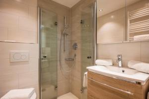a bathroom with a shower and a sink at Appartements Oswald in Ellmau +26 photos