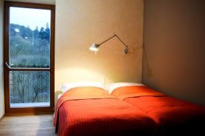 A bed or beds in a room at Hotel Kokořín