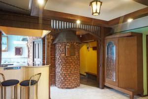 a kitchen with a brick oven in the middle at Apartament Erfolg 6 in Daugavpils