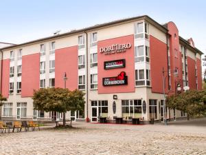 a building with a sign on the side of it at DORMERO Hotel Plauen in Plauen