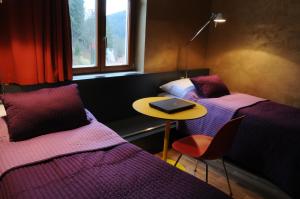 A bed or beds in a room at Hotel Kokořín