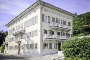 a large white building with balconies on it at Palazzo Exclusiv Appartment in Tegernsee