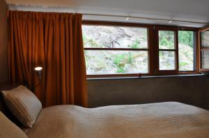 A bed or beds in a room at Hotel Kokořín