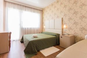 Postel nebo postele na pokoji v ubytování Hotel Benini