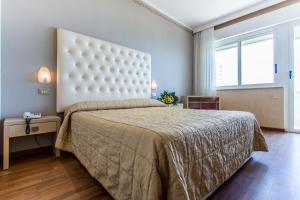 Postel nebo postele na pokoji v ubytování Hotel Benini