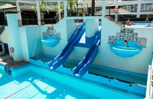 a swimming pool with a slide in a swimming pool at Benal Beach Apartment in Benalmádena