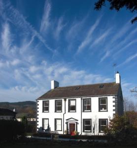 a white house with a sky in the background at Powe House in Keswick