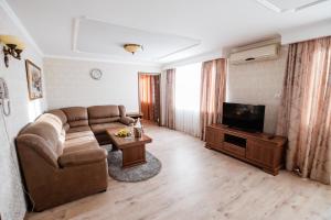 a living room filled with furniture and a tv at Hotel Ukraine in Chernihiv