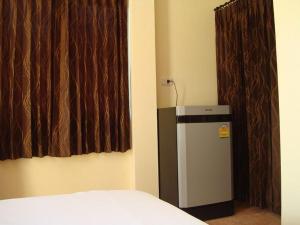 a small refrigerator in a room with a window at Bamboo Resort in Khanom +21 photos