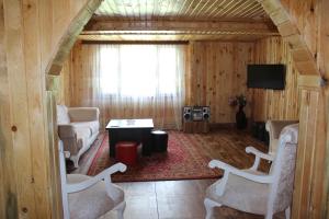 een woonkamer met een bank en een tafel en stoelen bij Luka House in Akhaldaba