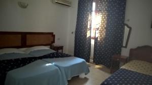 Postel nebo postele na pokoji v ubytování Hotel Excellence
