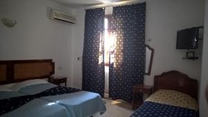 Postel nebo postele na pokoji v ubytování Hotel Excellence