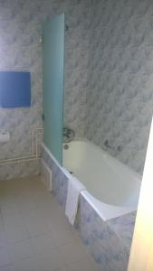 a bathroom with a bath tub in a room at Hotel Excellence in Tunis