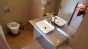a bathroom with a sink and a toilet at Kalias Hotel in Vasiliki