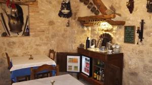 a restaurant with a table and chairs and a bar at Hotel Rural "El secreto del Castillo" in Maderuelo