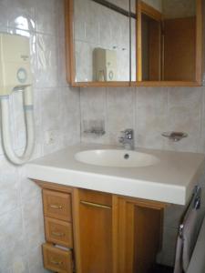 a bathroom with a sink and a mirror at Pension Köberl in Bad Mitterndorf