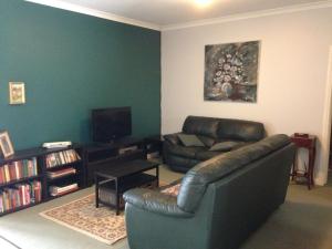 a living room filled with furniture and a tv at Weelaway On Gregory in Geraldton