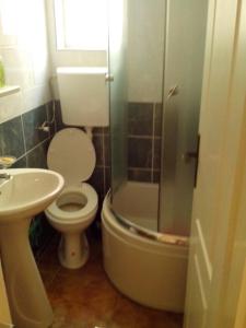 a bathroom with a toilet and a glass shower at VASILIJA, studio apartman in Budva