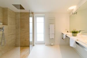 a bathroom with a shower and a sink at Hotel Villa Seeschau - Adults only in Meersburg