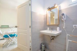 a bathroom with a sink and a mirror at Pensión Bellavista in Port de Pollensa