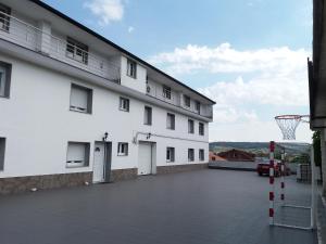 a large white building with a basketball hoop at Costa Da Morte in Vimianzo