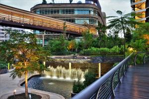 a building with a fountain in front of a pond at Holi Afiniti Themed Suites in Nusajaya +19 photos