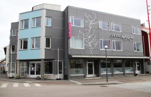 a building with a sign on the side of it at Hotel Marena in Andenes