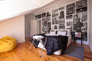 a bedroom with a bed and a wall of photos at Penthouse Lisboa 204 in Lisbon