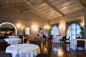 a dining room with white tables and chairs at Casa Americani in Montà